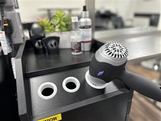 Sutter County Cosmetology School Hair Salon Station with hair dryer and hair products