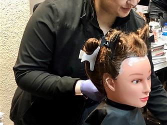 Cosmetology student learning about virgin relaxer services