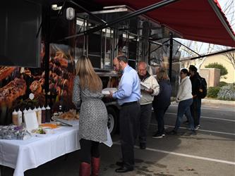 people eating outside a food truck