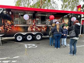People waiting in line at the culinary trailer at the Bok Kai Festival