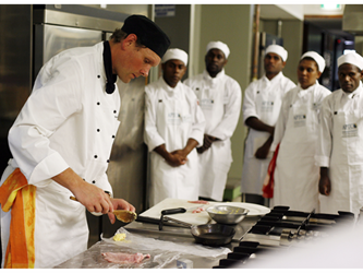 Chef in the kitchen with cooking assistants