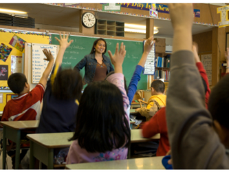 Students raising their hands in class