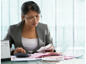 Woman analyzing paperwork on her desk