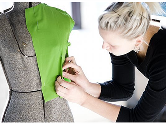 Woman putting clothes together on a manikin
