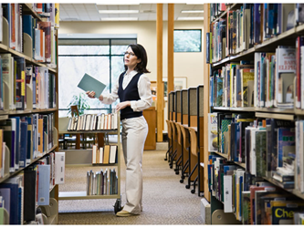 Woman putting books away in a library